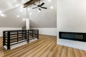 Additional living space featuring ceiling fan, vaulted ceiling with beams, and hardwood / wood-style floors