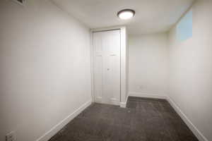 Bedroom featuring dark colored carpet