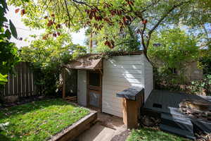 View of outbuilding with a lawn