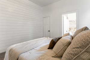 Bedroom featuring wooden walls