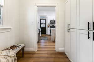 Hall with dark wood-type flooring