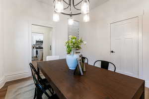 Dining space with a chandelier and hardwood / wood-style flooring