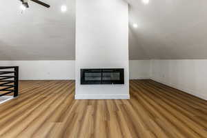 Additional living space with ceiling fan, vaulted ceiling, and hardwood / wood-style floors