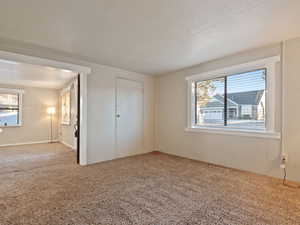 Unfurnished bedroom with a closet, carpet floors, and a textured ceiling