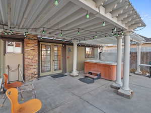 View of patio / terrace with french doors and a hot tub