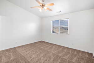 Carpeted spare room featuring ceiling fan