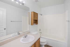 Full bathroom with vanity, toilet, bathtub / shower combination, and tile patterned floors