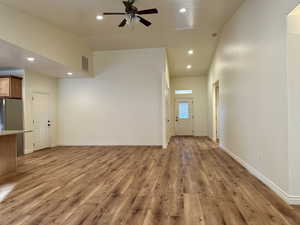 Stunning open-concept entry way with beautiful new flooring and modern lighting