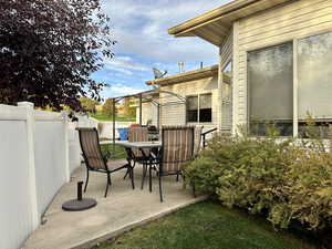 View of patio with furniture and grill that is included