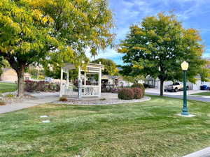 View of community featuring a lawn and gazebo