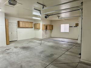 Garage with a garage door opener and built in cupboards