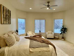 Carpeted primary bedroom featuring ceiling fan