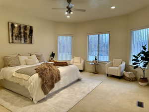 Primary Bedroom featuring ceiling fan great windows and carpet floors