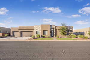 Pueblo-style home featuring a garage