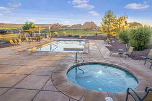 View of swimming pool featuring a patio area, a mountain view, and a community hot tub