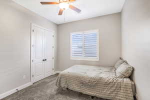 Bedroom featuring a closet, carpet flooring, and ceiling fan