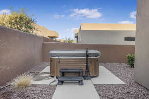 View of patio with a hot tub