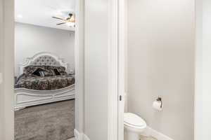 Bathroom with toilet and ceiling fan