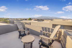 View of patio with a balcony and a mountain view