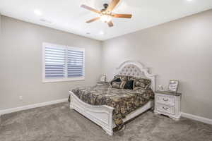 Carpeted bedroom with ceiling fan