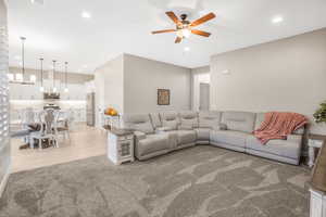 Living room with light wood-type flooring and ceiling fan