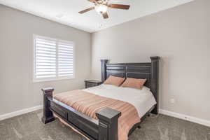 Bedroom featuring light carpet and ceiling fan