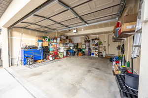 Garage with a garage door opener and a workshop area