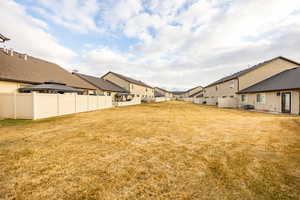 View of yard featuring a gazebo, fence, a residential view, and central air condition unit