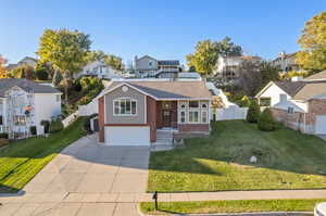 View of front of property featuring a front yard and a garage