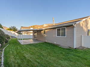 Back of house featuring a yard and a patio area