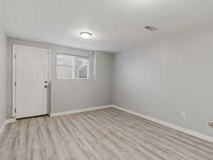 Unfurnished room with light hardwood / wood-style flooring