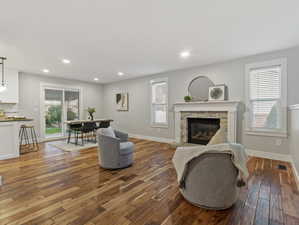 Living room featuring a stone fireplace and hardwood / wood-style floors