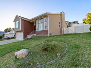 View of home's exterior with a yard and a garage