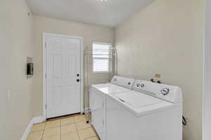 Tiled Laundry Upstairs with Door to Backyard