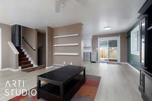 Living room with ceiling fan and light wood-type flooring