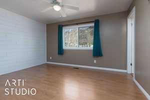 Unfurnished room with ceiling fan and light wood-type flooring