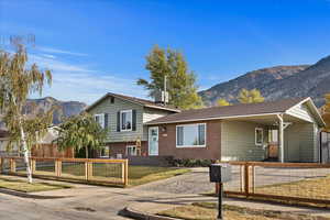 Split level home featuring a mountain view and central air condition unit