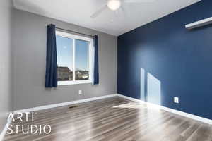 Empty room featuring hardwood / wood-style floors and ceiling fan