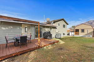 Back of house with a deck, privacy and moutnain views