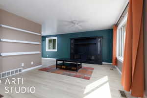 Living room featuring ceiling fan and light wood-type flooring