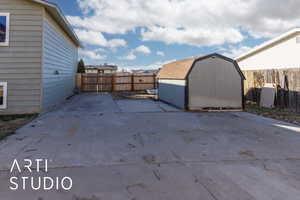 View of patio featuring a storage shed