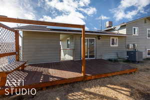 Rear view of property with central AC unit and a deck