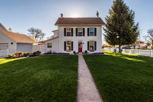 Colonial-style house with a front yard