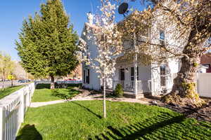 View of front facade with covered porch and a front yard