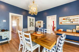 Dining space with a notable chandelier and hardwood / wood-style floors