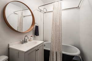 Full bathroom 3 featuring vanity, toilet, and shower / tub combo with curtain