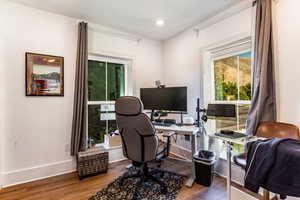 Office with dark wood-type flooring