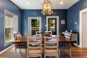 Dining space featuring a notable chandelier and hardwood / wood-style flooring