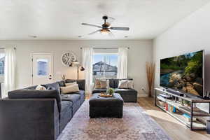 Living room featuring light hardwood / wood-style floors and ceiling fan