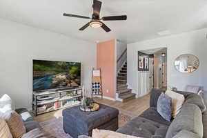 Living room featuring light hardwood / wood-style floors and ceiling fan